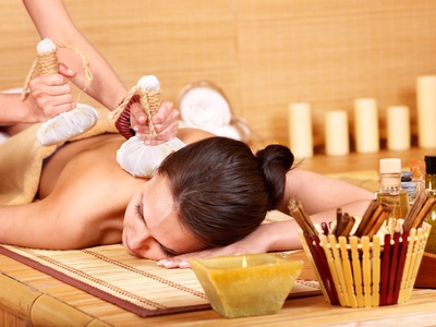 Woman getting massage in bamboo spa. Stempelmassage