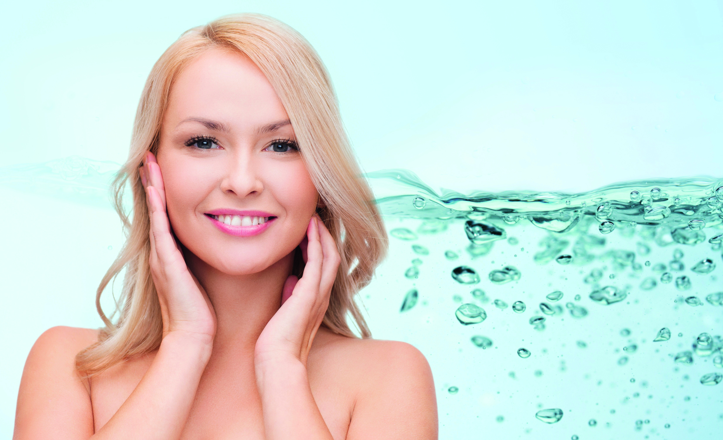 smiling young woman touching her face